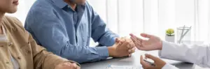 Healthy couple discussing fertility options with clinician