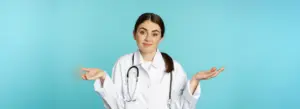 Portrait doctor woman intern shrugging shoulders smiling saying sorry dont know being clueles